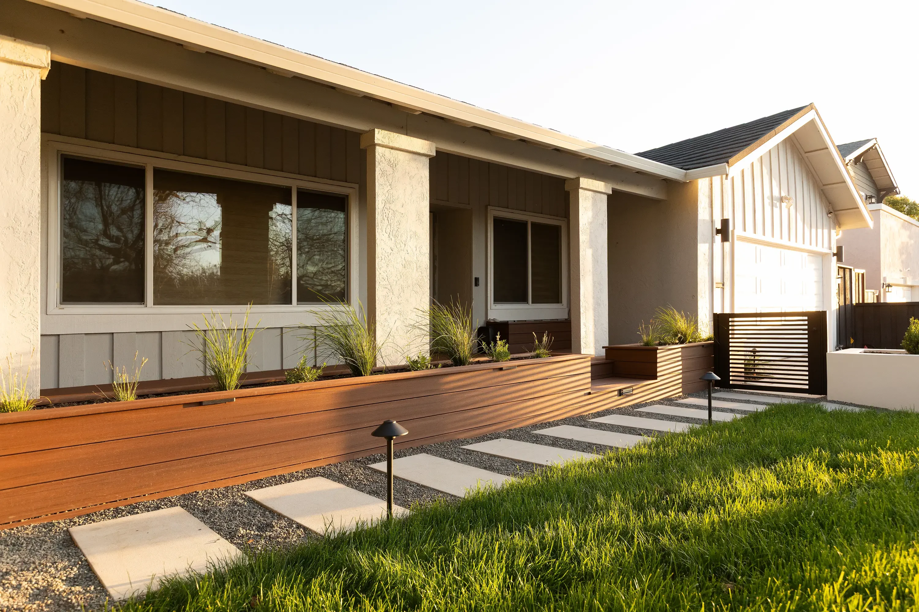 Completed hardscape installation featuring pavers, retaining wall, and outdoor living area