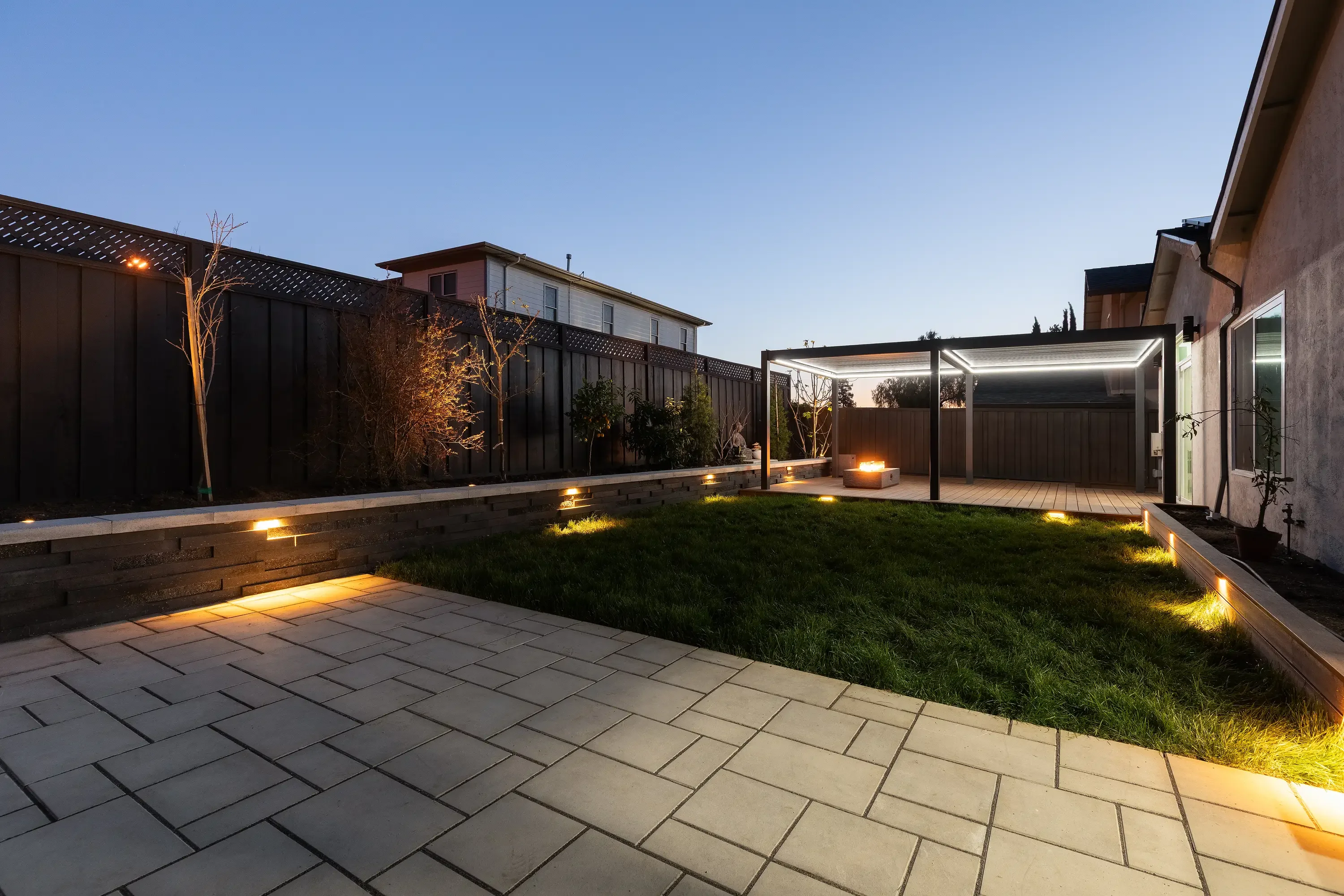 Custom pergola and fire pit installation in a residential backyard setting